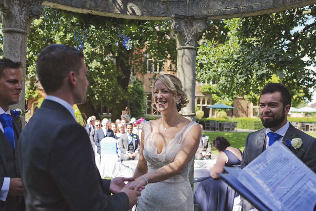 A bride and groom exchange vows at an outdoor wedding